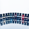 Set of 12 Papier Plume fountain pen ink bottles, each containing 15ml of colorful ink for writing and calligraphy.