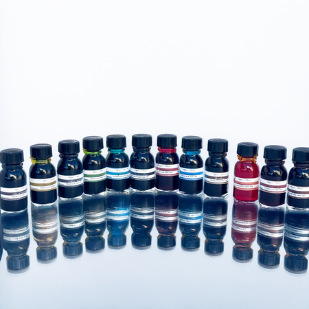 Set of 12 Papier Plume fountain pen ink bottles, each containing 15ml of colorful ink for writing and calligraphy.