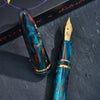 Esterbrook x BUNGUBOX Kingfisher Limited Edition Estie fountain pen with blue and gold design on a white background