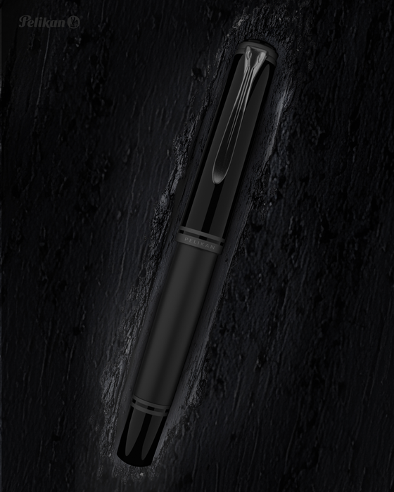 Pelikan Souverän M809 black matte fountain pen with gold accents and a smooth grip section, displayed on a white background.