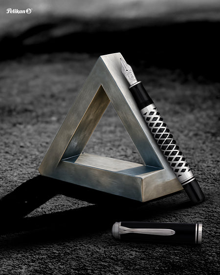 Pelikan Souverän M805 fountain pen with metal sleeve, featuring a glossy green body and gold accents, close-up view.
