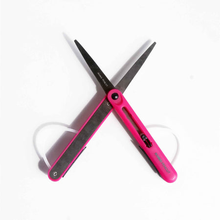 Pink KUM Pocket Scissors shown with compact design, stainless steel blades, and ergonomic handle for precise cutting.
