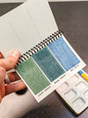 Peerless Watercolors Mini Complete Edition set with six watercolor sheets and vibrant paint swatches displayed on a white background.