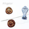 Le Potier D'etain wax seal with alligator design, featuring detailed craftsmanship and a shiny metallic finish.