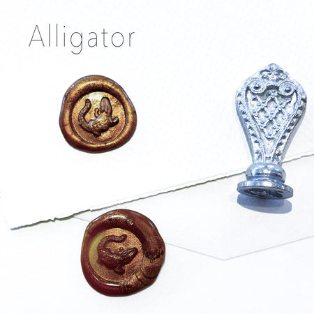 Le Potier D'etain wax seal with alligator design, featuring detailed craftsmanship and a shiny metallic finish.