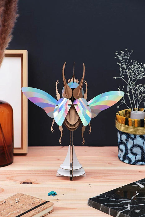 Colorful Paper Atlas Beetle craft by Assembli with vibrant rainbow wings, assembled from paper for creative arts and crafts projects.