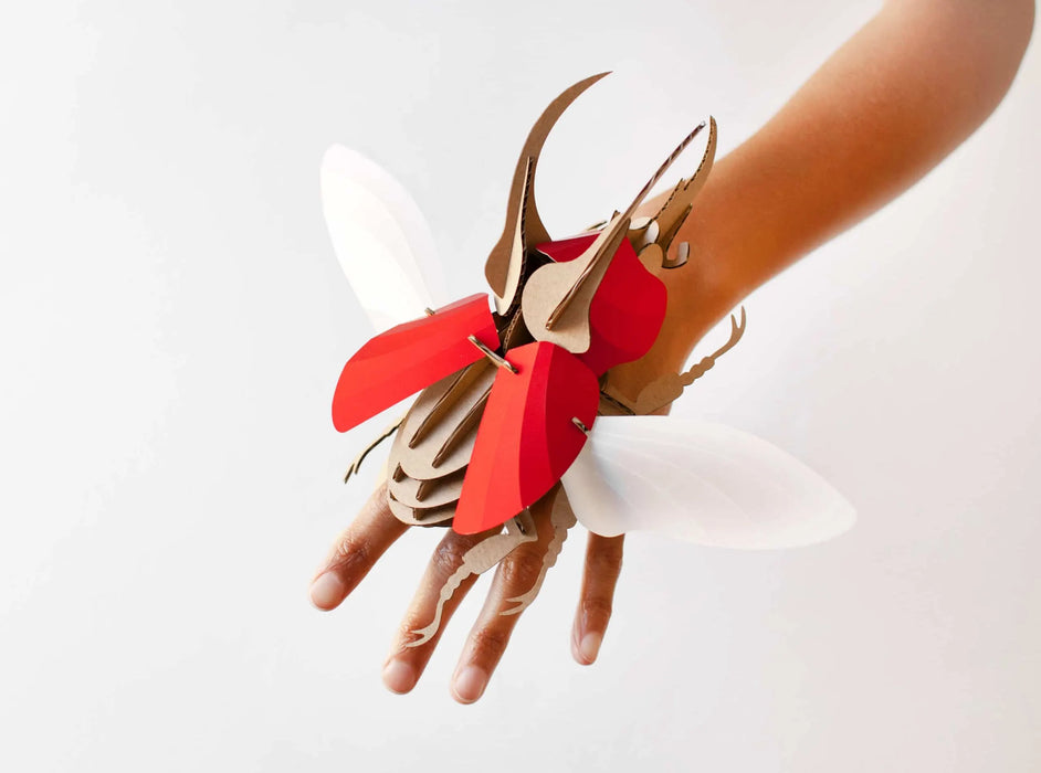 Red scaled Paper Atlas Beetle craft by Assembli, showcasing detailed large paper beetle with vibrant red colors and intricate design.