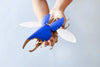 Blue Paper Hercules Beetle craft by Assembli featuring detailed wings and large body, perfect for educational or decorative projects.