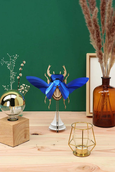 Large paper stag beetle craft from Assembli, featuring detailed blue paper wings and body, perfect for creative arts projects.