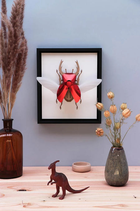 Large paper stag beetle craft by Assembli, featuring detailed paper wings and body on a transparent background.