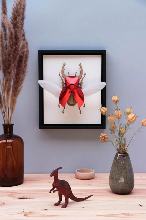 Large paper stag beetle craft by Assembli, featuring detailed paper wings and body on a transparent background.