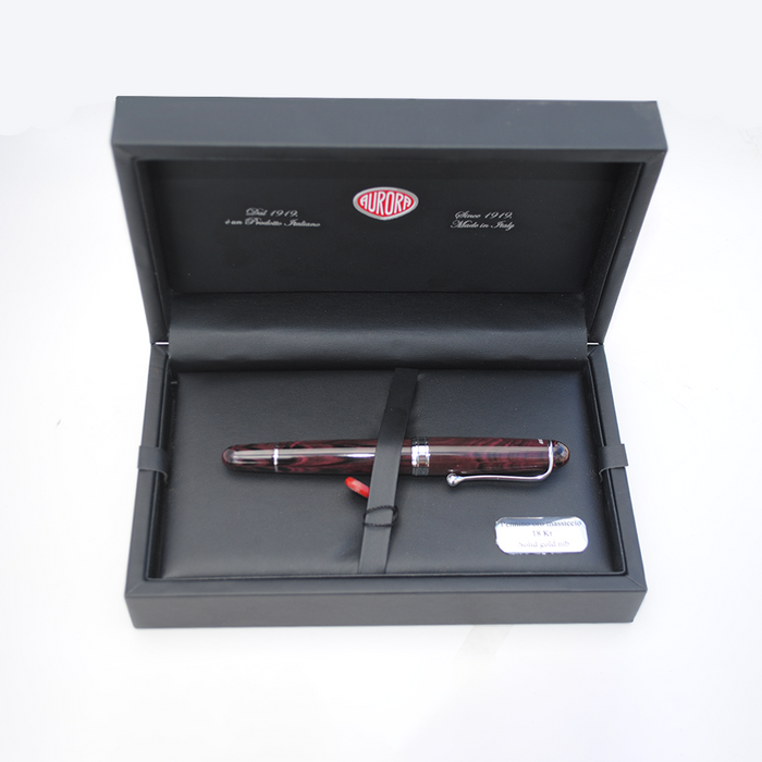 Aurora Ebonite Magenta fountain pen with sleek design and gold accents, showcasing its elegant nib and vibrant purple body.