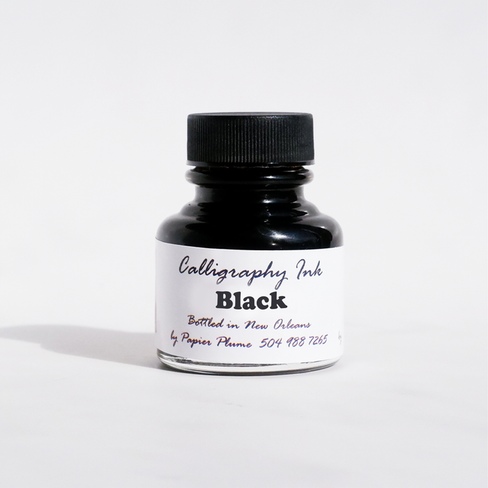 Black bottled calligraphy ink by Papier Plume in a glass bottle, showcasing smooth, rich ink ideal for elegant calligraphy writing