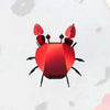 Colorful paper beach crab craft by Assembli, featuring vibrant paper textures and detailed crab design for creative projects.