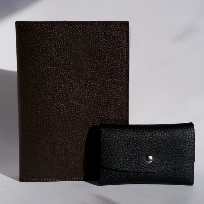 Swatch Books set by Papier Plume featuring a brown textured swatch book with fabric-like surface and color samples.