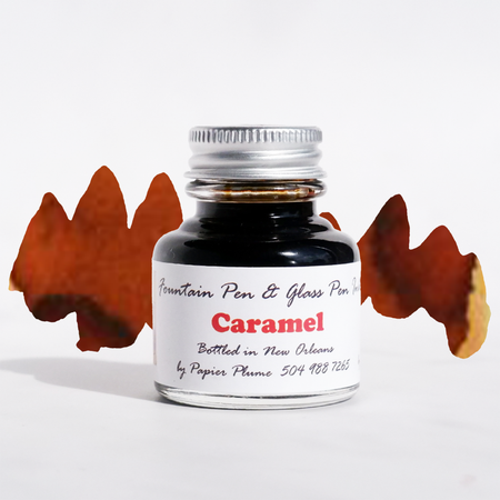 Papier Plume caramel fountain pen ink bottle with ink swatch showing warm caramel color on white background