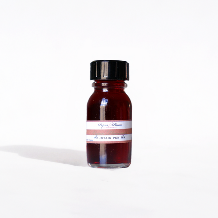 Papier Plume Cajun Flamingo fountain pen ink in a 15ml bottle, vibrant pink-orange ink with a smooth flowing design.