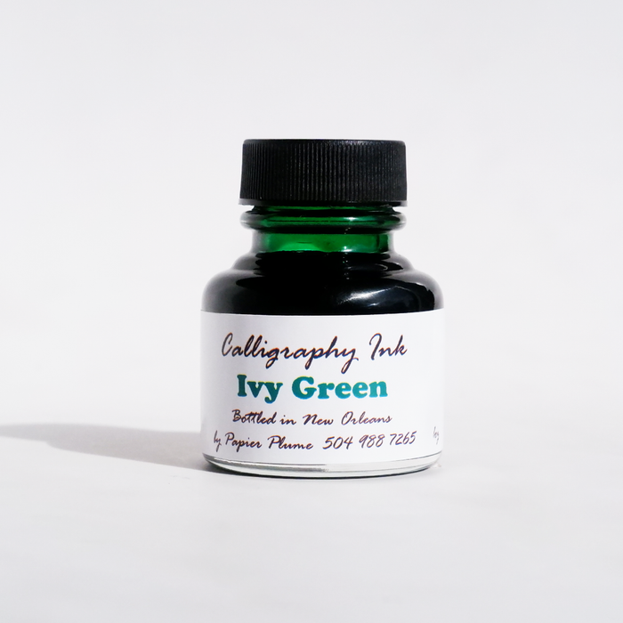 Papier Plume bottled calligraphy ink in Ivy Green, featuring a glass bottle with green ink inside on a white background.