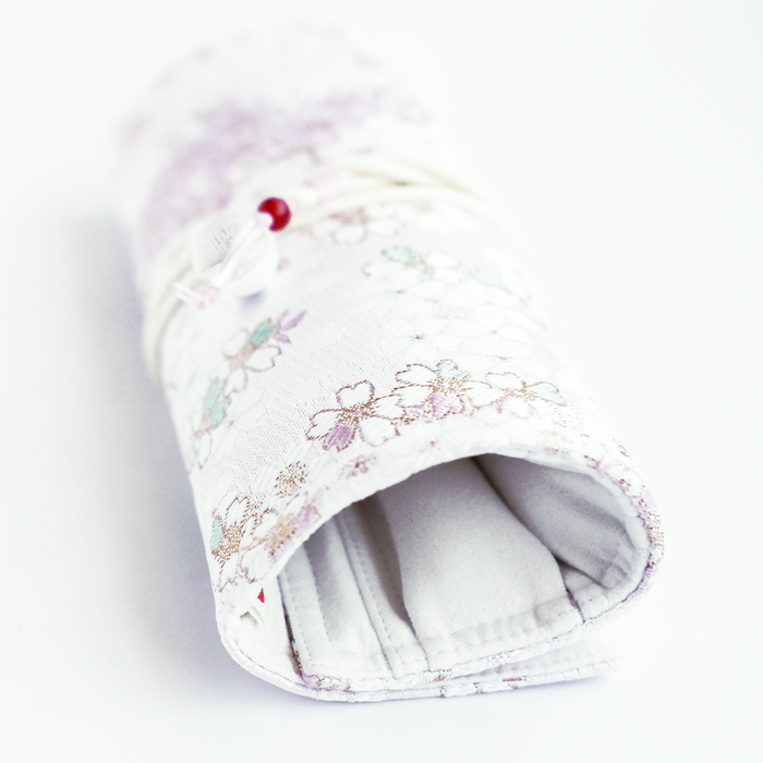 Cathay Snowlit Bloom pen case showing a floral design with a zipper closure and compact shape for storing writing instruments.