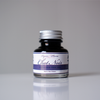Papier Plume Chat Noir fountain pen ink bottle with black ink in a glass container, designed for elegant writing.