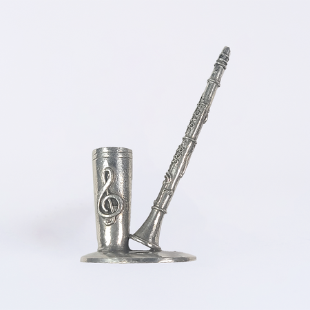 Pewter clarinet-shaped pen rest by Le Potier D'Étain, designed to hold a quill or writing instrument securely.