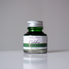 Papier Plume Colibri fountain pen ink bottle with vibrant blue ink in a clear glass container.