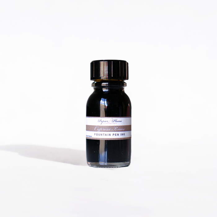 Papier Plume Cypress Knees fountain pen ink in a 15ml bottle with a clear label and black cap, designed for smooth writing.