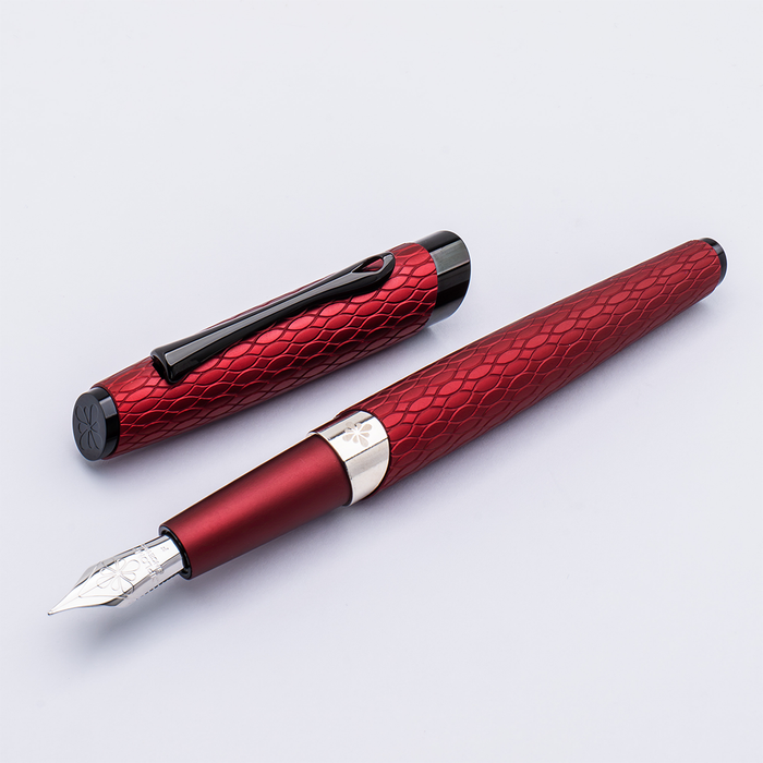Diplomat Cobra burgundy red fountain pen with gold accents, close-up view showing smooth barrel and elegant design.