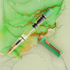 Twsbi Eco Jade Jelly fountain pen with bronze accents on a white background