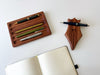 Eng Leather Co. wooden pen tray with compartments for organizing pens and accessories, crafted from quality leather and wood.