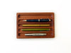 Eng Leather Co. wooden pen tray with a sleek, polished finish designed to hold and organize pens and small stationery items.