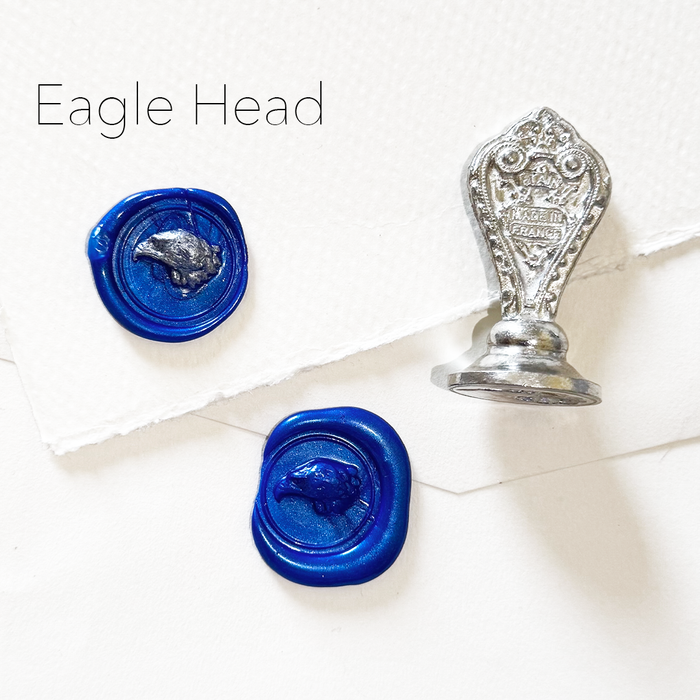 Le Potier D'etain wax seal featuring a detailed eagle head design on a metallic seal stamp.