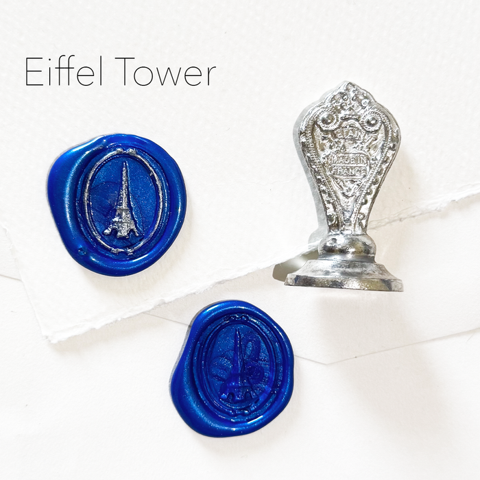 Le Potier D'etain wax seal featuring an Eiffel Tower design on a white background.
