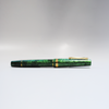 Gioia Metis 2.0 fountain pen in emerald green with gold accents, showcasing its sleek design and elegant craftsmanship.