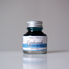Papier Plume Esplanade fountain pen ink bottle with vibrant blue ink, showcasing the elegant ink packaging and label.