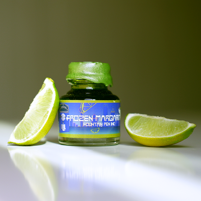 Papier Plume Frozen Margarita shimmer fountain pen ink in a glass bottle with vibrant blue and green hues.
