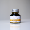 Papier Plume Girasole fountain pen ink in a 30ml bottle with vibrant yellow-orange ink visible in the bottle.