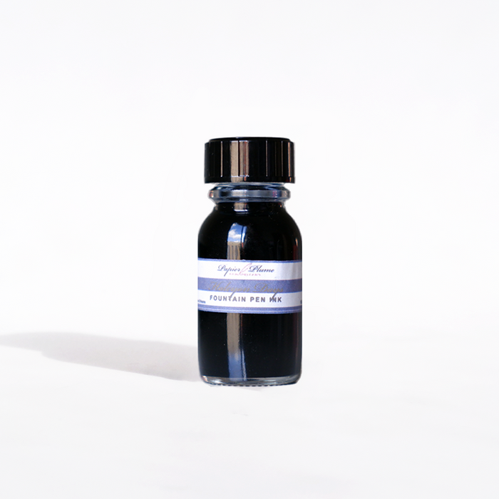 Papier Plume Halcyon Days fountain pen ink in a 15ml glass bottle with a black cap, vibrant ink color visible in the image.