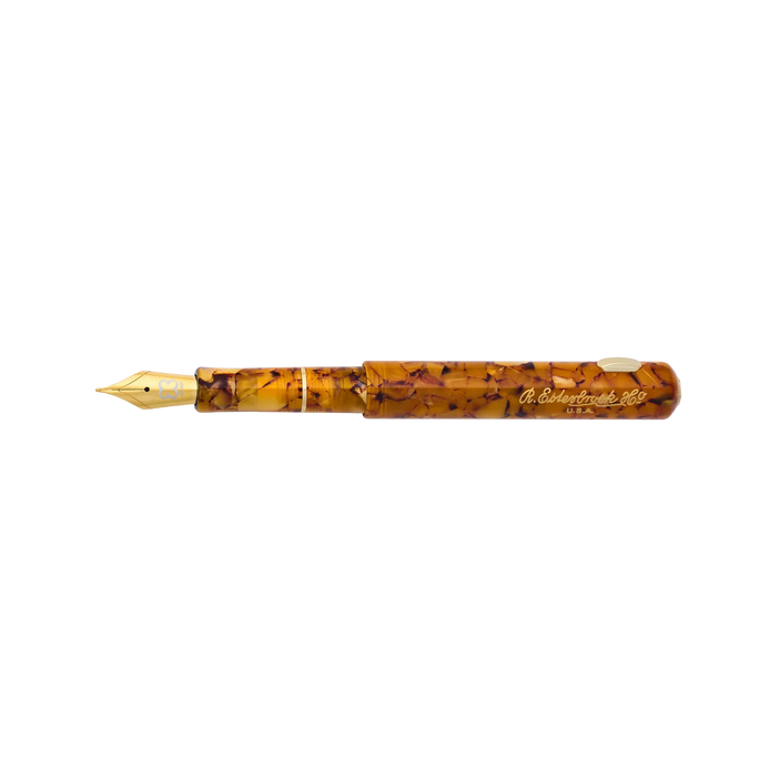 Esterbrook Niblet fountain pen with honey-colored resin barrel and gold-tone nib, showcasing elegant vintage design.