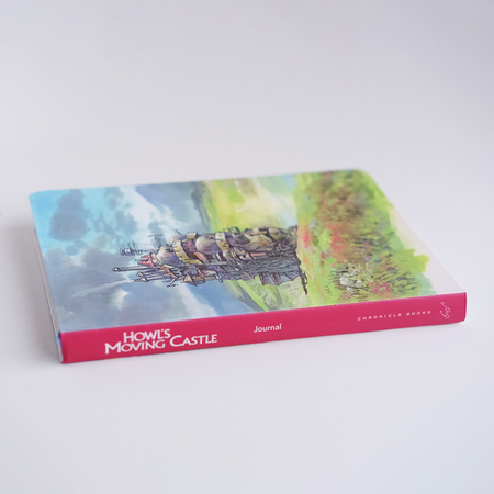 A small journal featuring artwork inspired by Howl's Moving Castle, with a charming cover design by Chronicle Books.