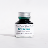 Papier Plume fountain pen ink bottle with Ivy Green ink, showcasing the rich green color in a sleek glass container.