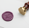 Papier Plume wax seal featuring a J-script monogram on a natural wax surface, ideal for elegant correspondence and embellishments.