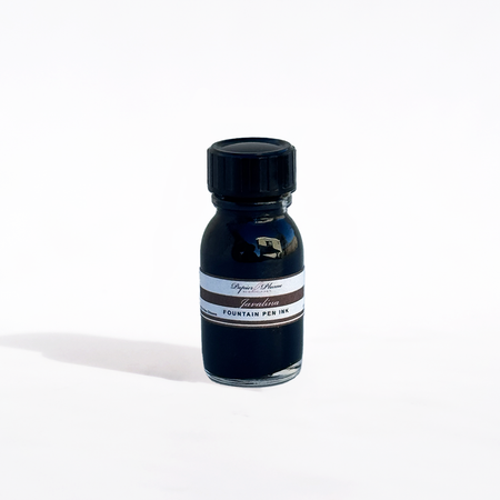 Papier Plume Javalina fountain pen ink bottle with black ink, featuring a clear glass container and black ink inside.