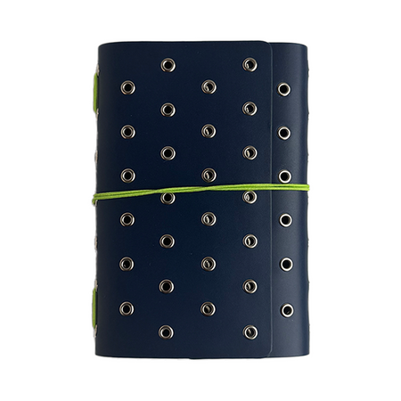 A Juniper-colored A6 journal cover by Imperfect Concepts with deep sea accents and silver grommets, featuring a trifold folio design.