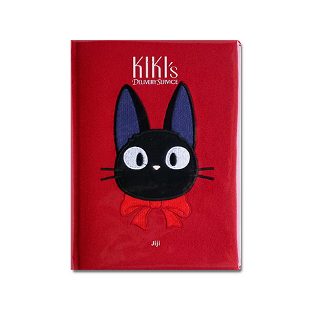 Red notebook with a black cat illustration and 'Kiki's Delivery Service' branding on a white background