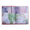 Open book with a scenic illustration of a garden and building.