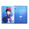 Open book with an illustration of a character and a sailboat on a blue background