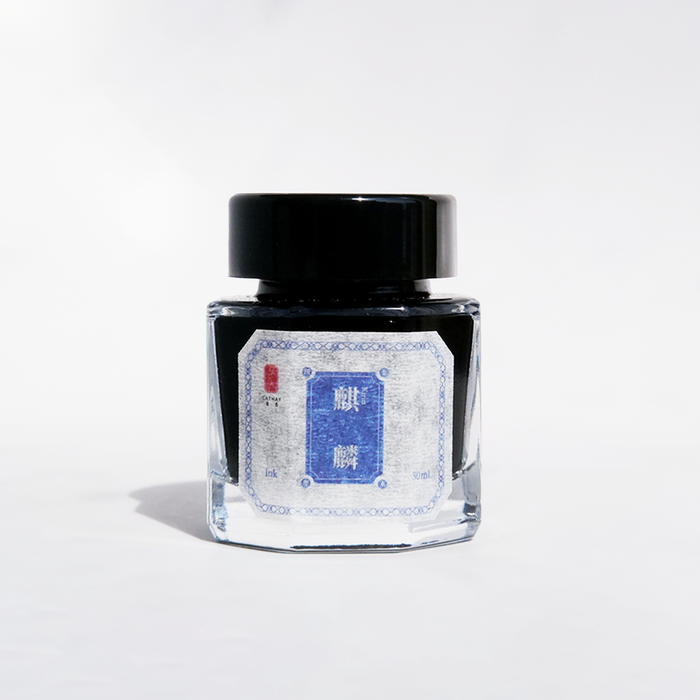 Bottle of Cathay Kirin fountain pen ink with a clear glass container and black ink inside.