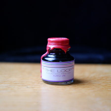 Papier Plume The Loop Series fountain pen ink in purple, featuring a sleek ink bottle with a modern label.
