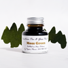 Moss green fountain pen ink in a Papier Plume ink bottle, showcasing the rich, earthy color for writing and calligraphy.